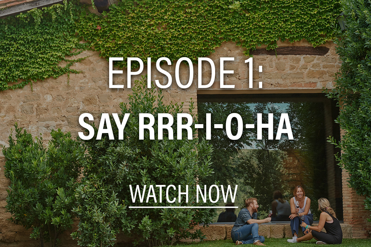 women in front of a moss covered building with text overlay that says episode 1: say rrr-i-o-ha, watch now