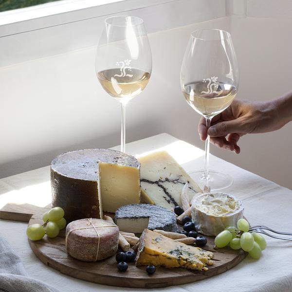 cheese plate with two glasses of white wine