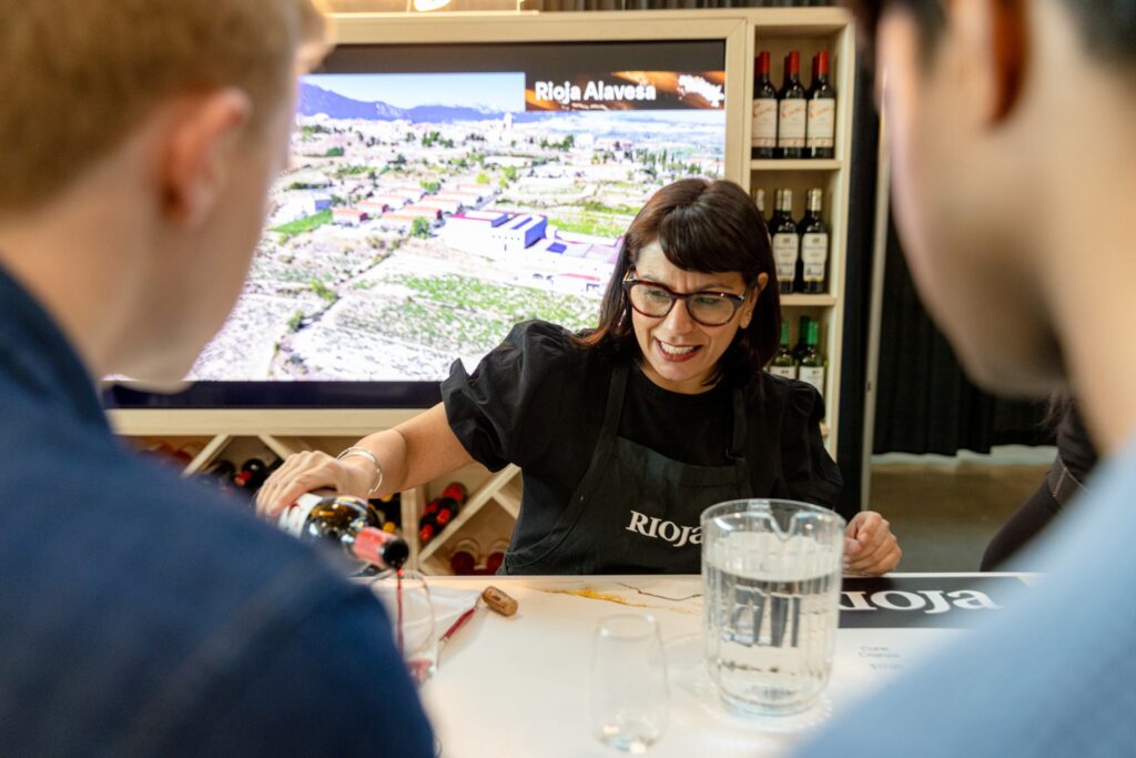 A woman pours wine at Toronto Wine Fest